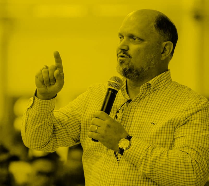 Chairman J.D. Slaughter holding a microphone and speaking to an audience