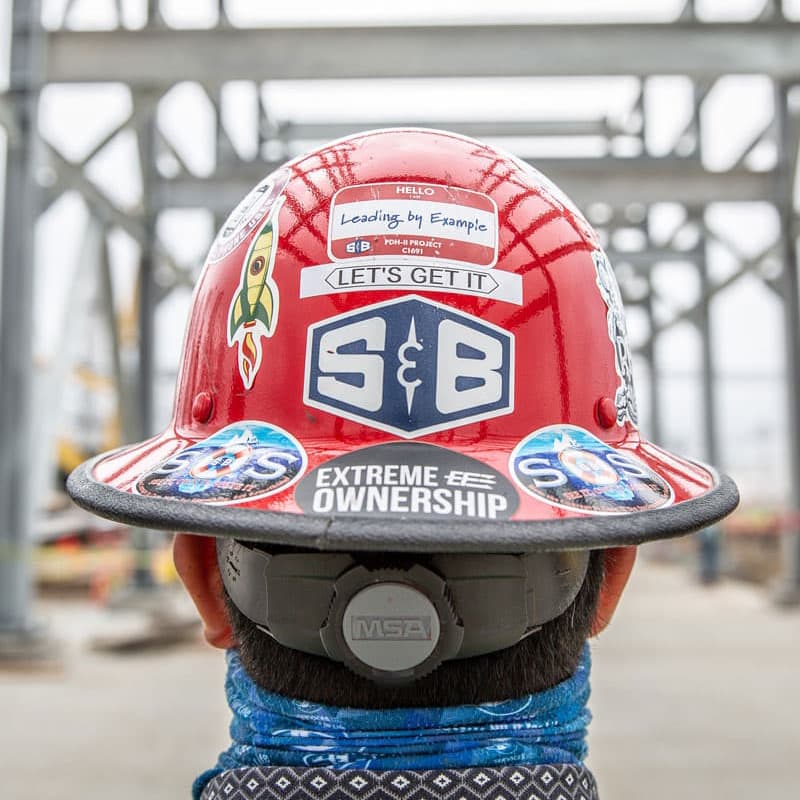 An S&B safety hat tricked out with stickers
