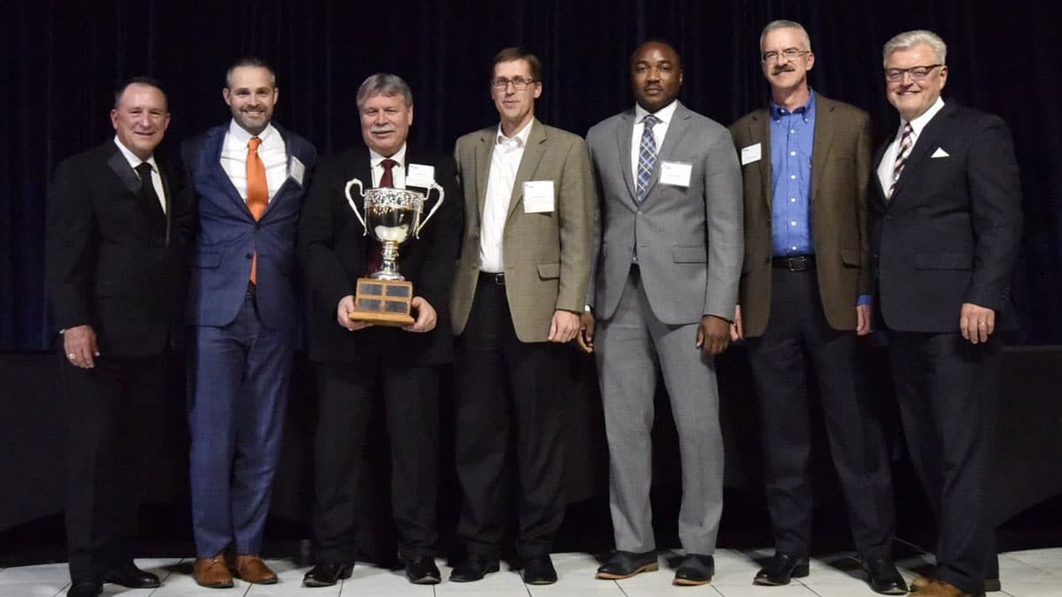 S&B team members holding a large trophy at the 21st annual Excellence in Construction Awards (EIC)