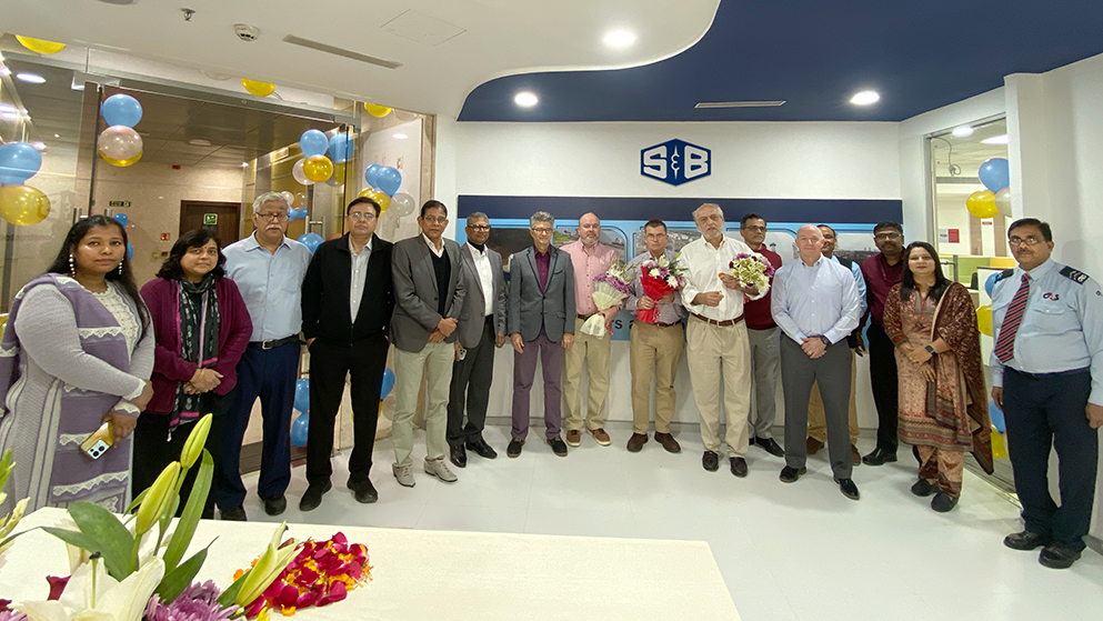 The S&B Noida, India team standing together in their new expanded office foyer