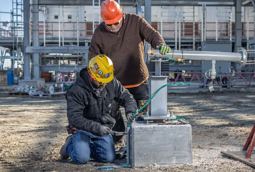 Two S&B workers cutting wire at a construction site