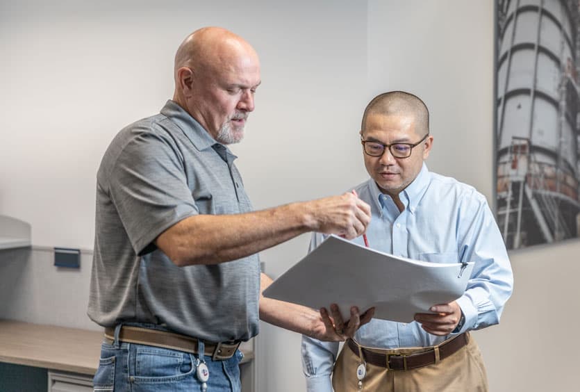 An S&B employee walking through plans with a young professional