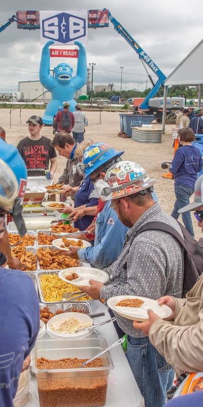 S&B workers in line at an ourdoor buffet table