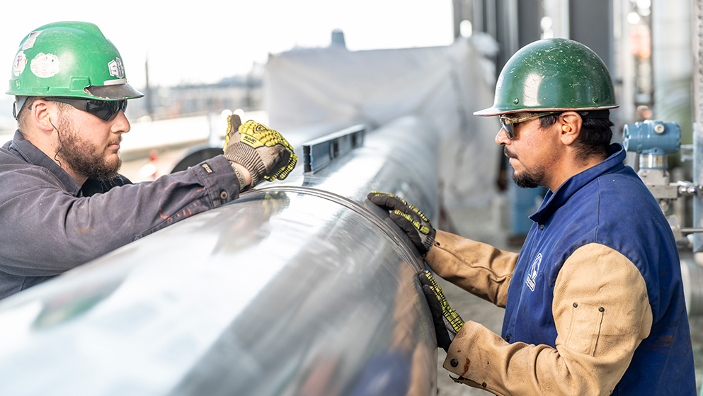 Two S&B construction workers reviewing construction work.