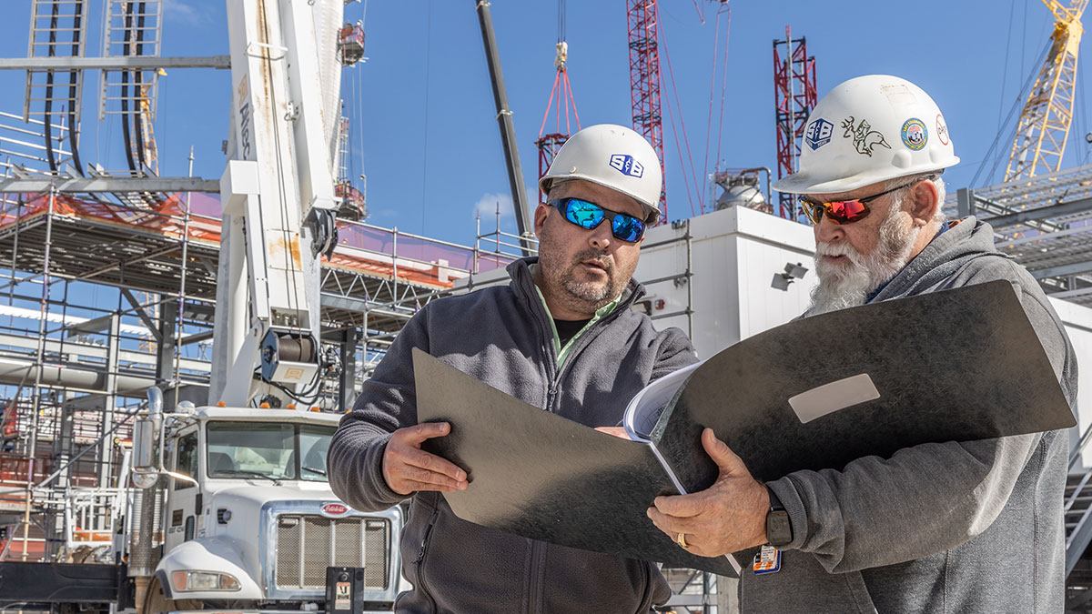 Two S&B construction workers reviewing construction plans