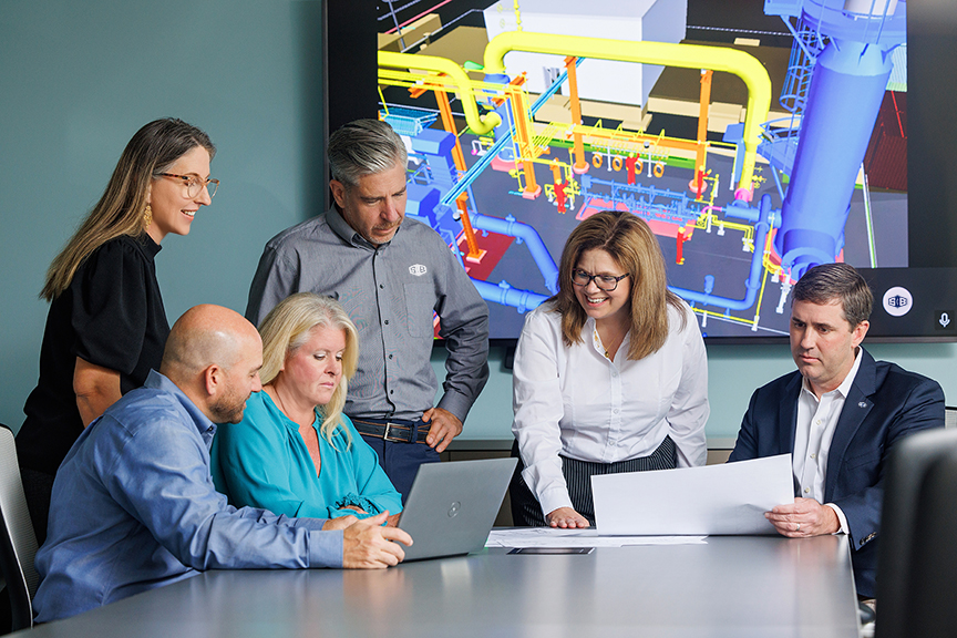 The S&B team gathered around a conference table, reviewing schematics and 3D images of their latest EPC project in Louisiana