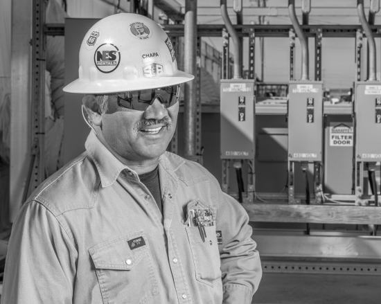 A smiling S&B Employee working on site