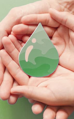 Hands holding a green water droplet sticker