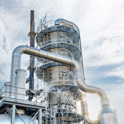 A large steal gas container at a refinery