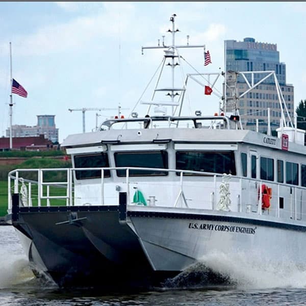 A U.S. Army Corps of Engineering ship driving through a harbor