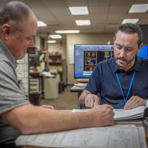 S&B engineers going over documentation in an office