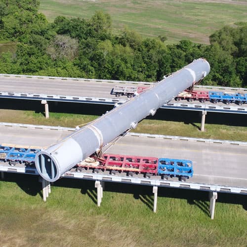 A large pipe straddling across two bridges